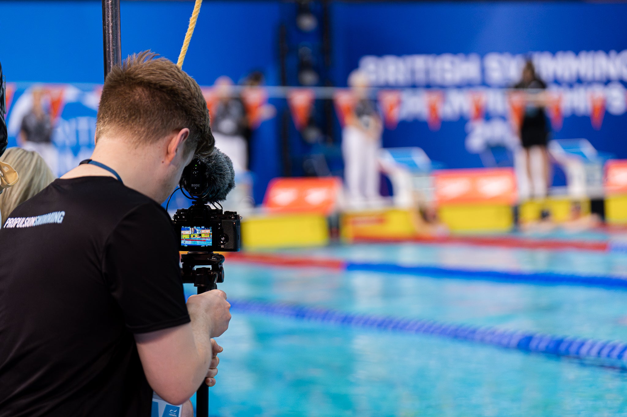 Scott from Propulsion Swimming filming the British Swimming Championships 2023 wear a Technical poolside top